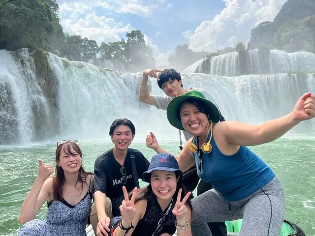 Five friends having fun on a boat ride at Ban Gioc Waterfall.