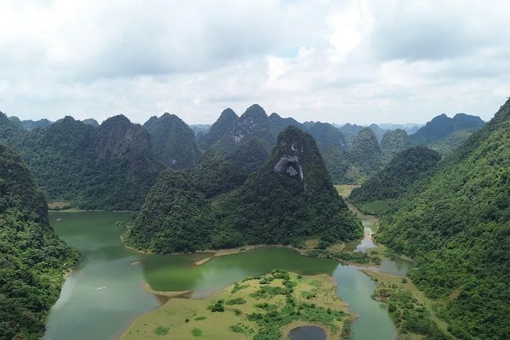 Aerial view of Angel Eye Mountain and surrounding karst landscape with lake.